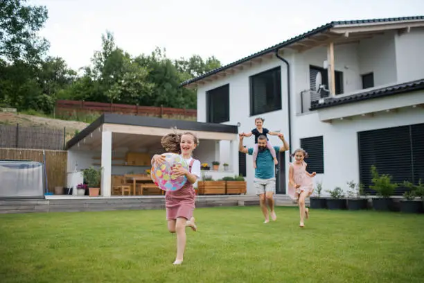 Family playing outdoors for personal insurance planning